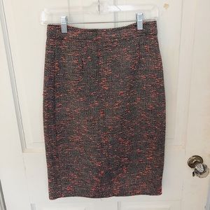 Tweed grey and white, with orange detailing skirt